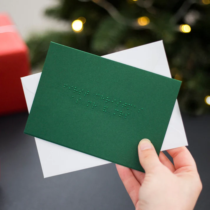 Christmas card in forrest green which says First Christmas as Mr & Mrs Card in Braille